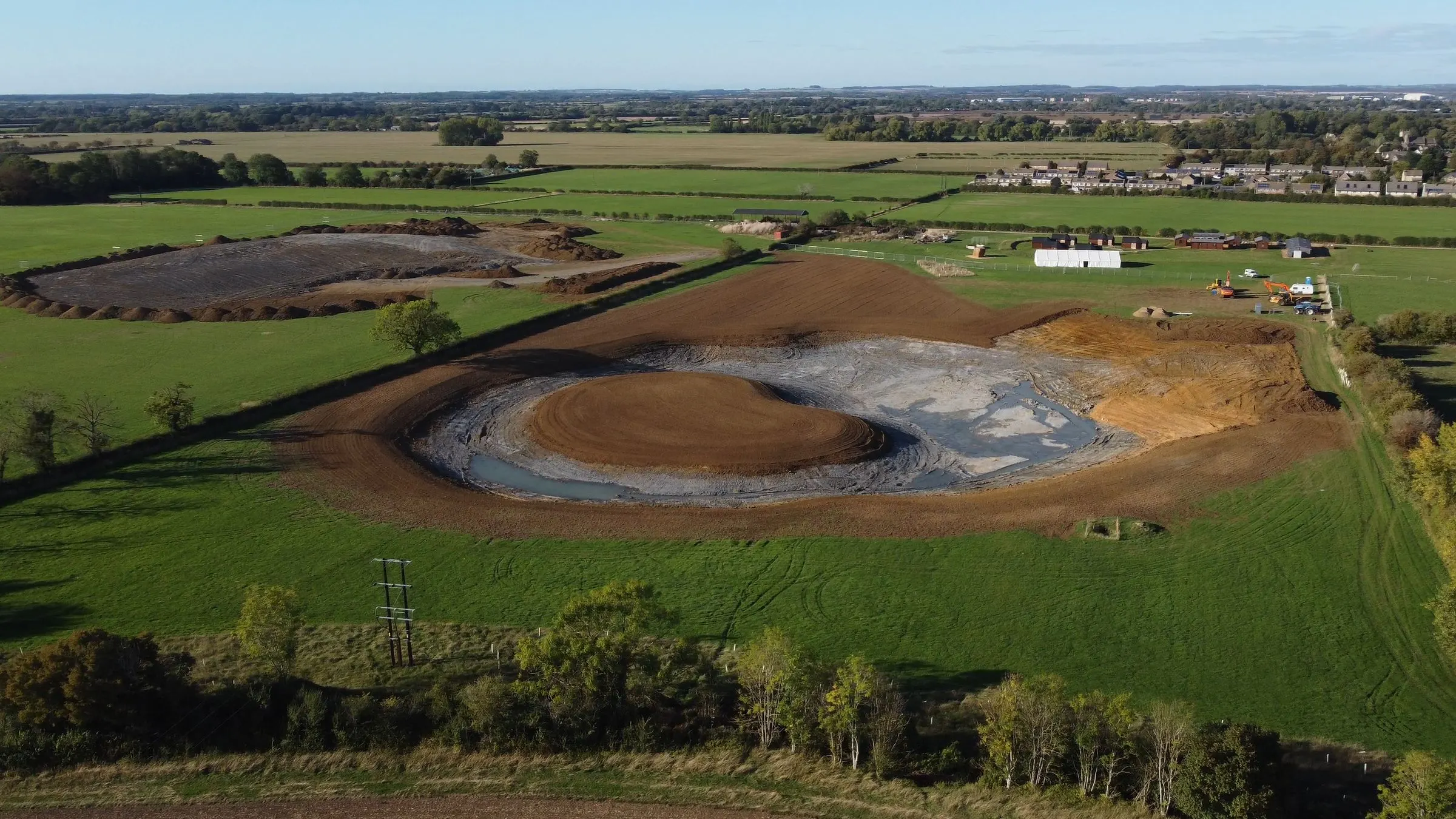 Aerial view of the newly dug Adventure Lake in the fields beside the site