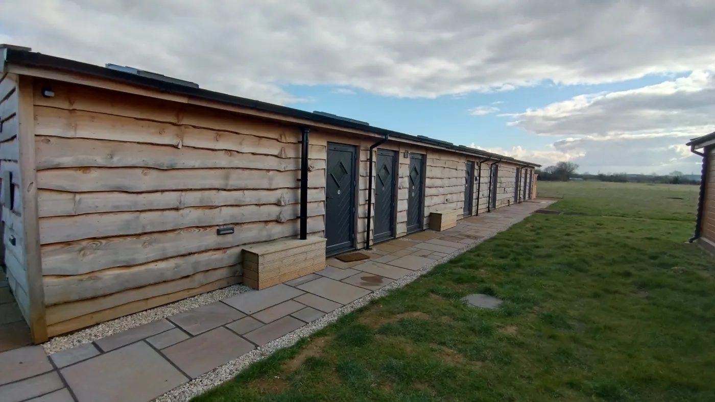 The shower block by the yurts and cabins, with a paved path along its doors