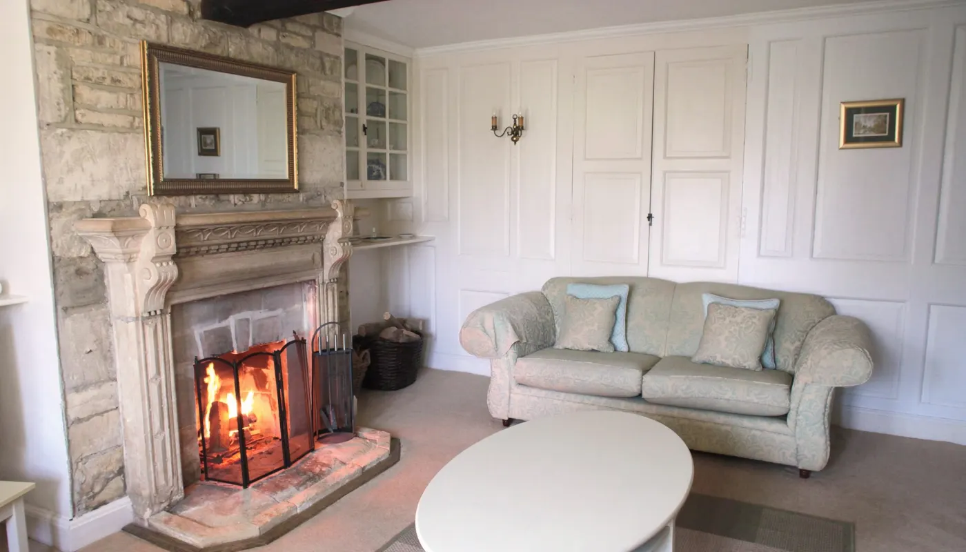 The sitting room at Lower Farm with the fire lit