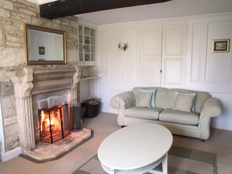 The sitting room with the fire lit
