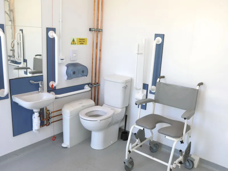 The accessible shower room, with grab rails and a shower chair