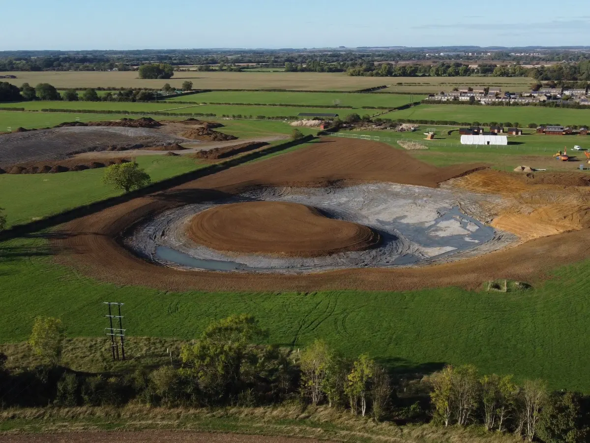 Aerial view of The Lake being dug in the fields beside the site